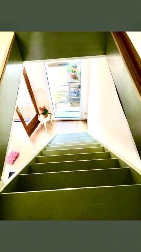 a room with stairs with a door and a plant at Foodiejive in Antwerp