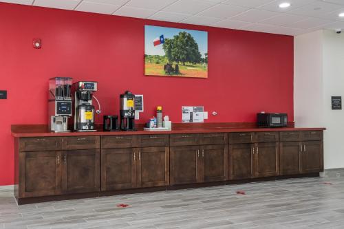 a counter in a room with a red wall at Americas Best Value Inn & Suites Katy in Katy
