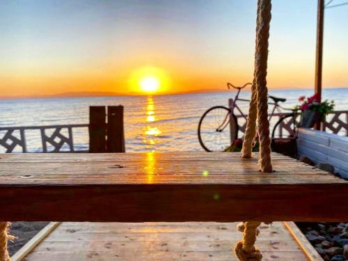 a bike sitting on a dock with a sunset at Happy Land Hotel Dahab in Dahab