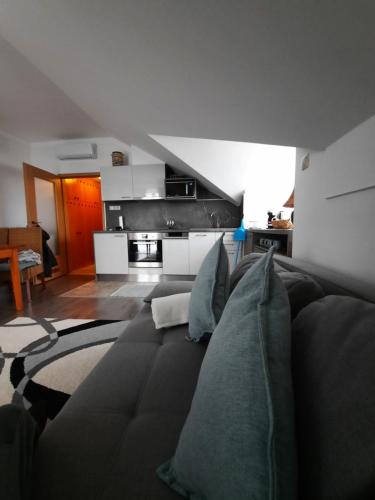 salon z czarną kanapą z poduszkami w obiekcie Kamilla Apartman Villapark w mieście Bük