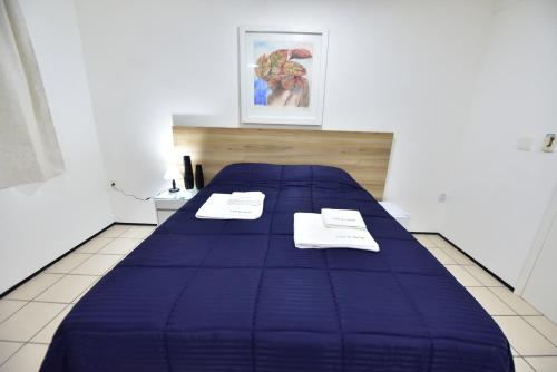 a blue bed with two napkins on top of it at LIVE IN FORTALEZA HOTEL in Fortaleza