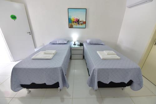 two beds sitting next to each other in a room at LIVE IN FORTALEZA HOTEL in Fortaleza