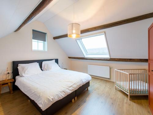 a bedroom with a large bed and a window at Zoutelandseweg 2, Biggekerke in Biggekerke