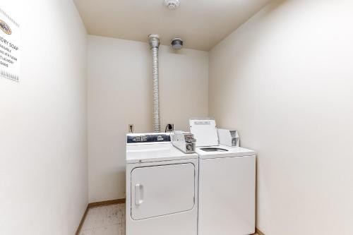 a laundry room with a washer and dryer at Zephyr Mountain Ski-In Ski-Out Condo in Winter Park