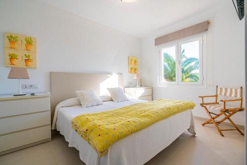 a bedroom with a bed with a yellow blanket on it at LA PLETA in Es Llombards