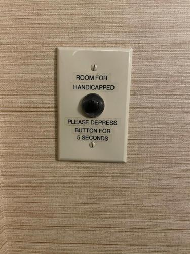a lightswitch with a button on a wooden wall at Holiday Inn Express Philadelphia Penn's Landing by IHG in Philadelphia