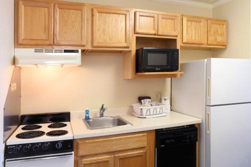 a small kitchen with a sink and a white refrigerator at Quality Inn Boardwalk in Ocean City