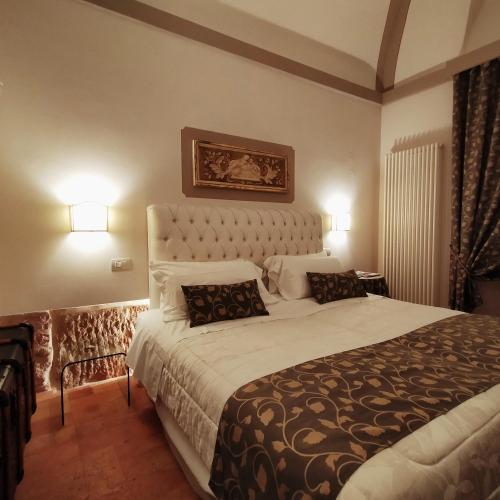 a bedroom with a large bed and two pillows at Case Brizi 10 in Assisi