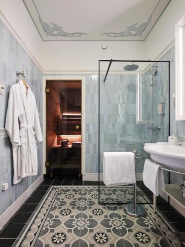 a bathroom with a sink and a shower at Villa Ammende Restaurant and Hotel in Pärnu