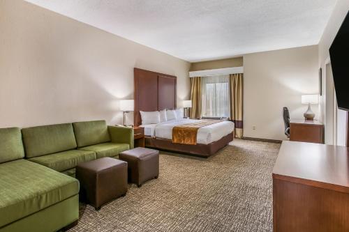 a hotel room with a bed and a couch at Aspire Hotel and Suites in Gettysburg