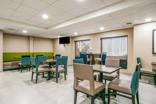 a waiting room at a hospital with tables and chairs at Aspire Hotel and Suites in Gettysburg