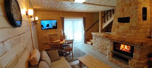 a living room with a couch and a fireplace at Vikendica Vila Despotovic in Kopaonik