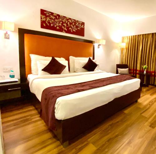 a bedroom with a large bed in a hotel room at Gis Select Banjara Hill in Hyderabad