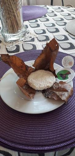 a plate of food with a sandwich on a table at La Campagne de Lili - Chambre et Cuisine sur Terrasse privée in Ongles