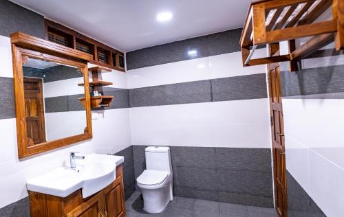 a bathroom with a sink and a toilet at Kalpavanam Heritage Resort in Thekkady