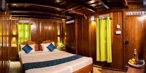 a bedroom with a bed on a boat at Kalpavanam Heritage Resort in Thekkady