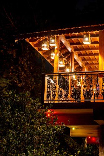 a balcony with lights on it at night at Kalpavanam Heritage Resort in Thekkady