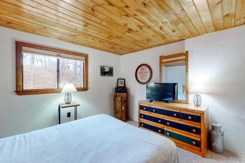 a bedroom with a bed and a tv on a dresser at N10 Sandtrap Loop in Bartlett