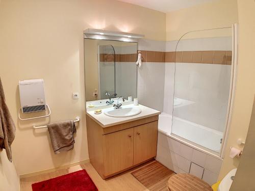 a bathroom with a sink and a shower at Appartement 209 Résidence du Grand Hotel Aulus-les-Bains in Aulus-les-Bains