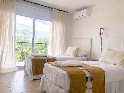 מיטה או מיטות בחדר ב-Prado del Lago