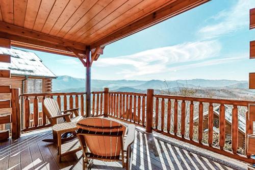a deck with a table and chairs and a view at Mountain Top View Retreat in Sevierville