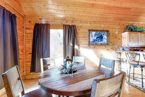 a wooden dining room with a wooden table and chairs at Mountain Top View Retreat in Sevierville
