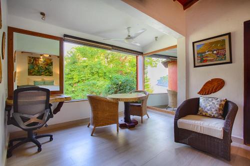 a living room with a table and chairs and a window at Villa Lala Boutique Hotel Adults Only in Puerto Vallarta