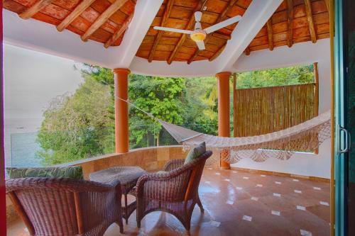 a hammock on the porch of a house at Villa Lala Boutique Hotel Adults Only in Puerto Vallarta