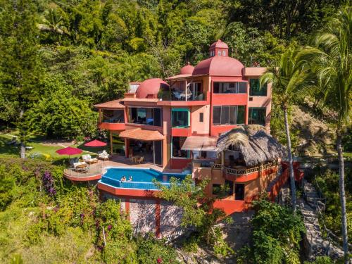 a large house with a swimming pool on a mountain at Villa Lala Boutique Hotel Adults Only in Puerto Vallarta