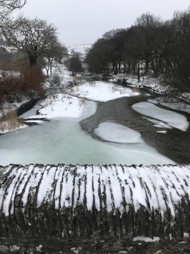 a pool of water with snow on the ground at The Royal Oak Inn in Withypool