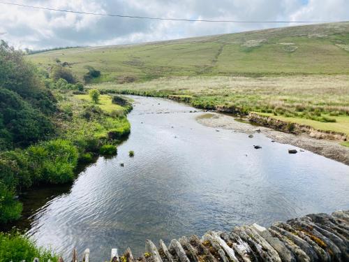 a river in the middle of a field at The Royal Oak Inn in Withypool