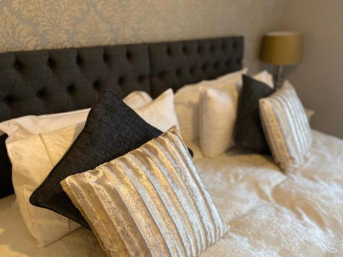 a bed with pillows and a headboard with at The Royal Oak Inn in Withypool