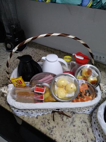 a basket of food on a counter with food at Pousada Anjos - à 2 quadras do mar in Matinhos