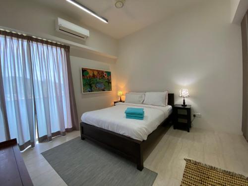 峇都丁宜的住宿－海濱公寓@溫馨海濱之家（峇都丁宜）。，一间卧室设有一张床和一个大窗户