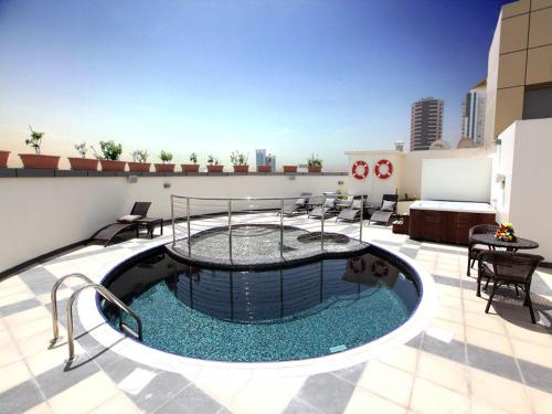 a pool on the roof of a building at Xclusive Maples Hotel Apartment in Dubai