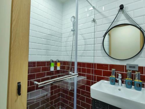 a bathroom with a sink and a mirror at 濱境行旅 Begin Inn in Xiaoliuqiu