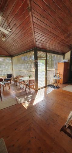 a large room with wooden floors and a wooden ceiling at Chinnock B&B in Gilgandra