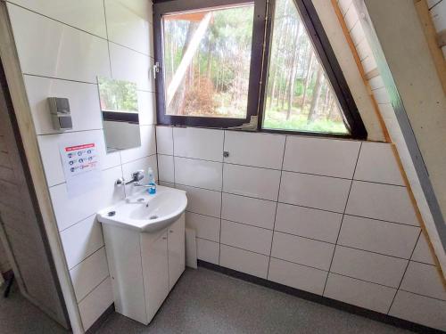a bathroom with a sink and a window at Ośrodek Wypoczynkowy AKWA Marina in Nysa