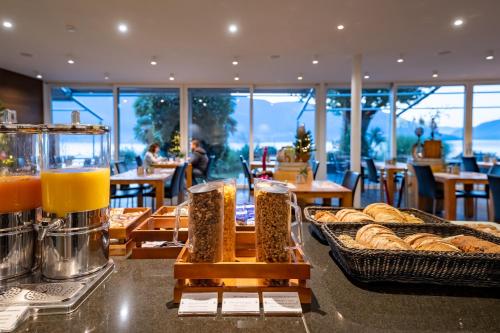 a bakery with bread and baskets of food on a counter at Hotel Collinetta in Ascona