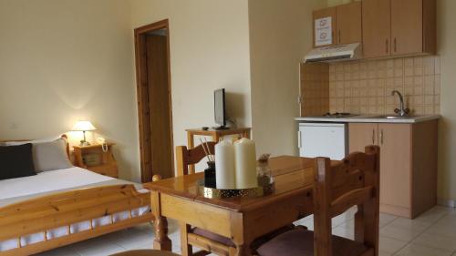 a bedroom with a bed and a table with a candle at Fani Hotel in Loutra Edipsou