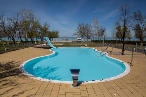 a swimming pool with a slide in a park at Aranypart Camping in Siófok