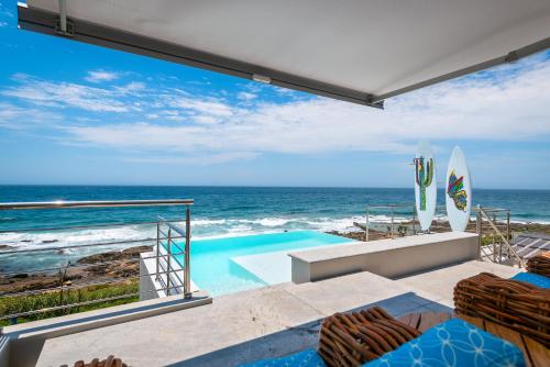 a swimming pool with a view of the ocean at The Sugar Shack in Ballito
