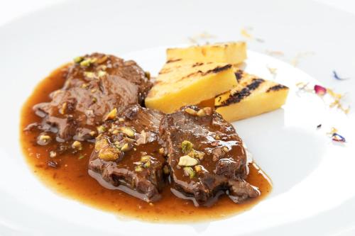 a plate of food with chocolate pudding and cheese at Hotel Romantic in Cavaion Veronese