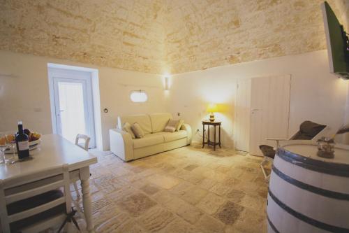 a living room with a couch and a table at MASSERIA SCALEDDA in Manduria