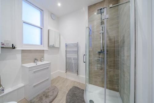 a bathroom with a shower and a sink at Upper Thames & Lower Thames - Stunning apartments in Henley on Thames