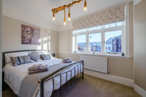 a bedroom with a large bed and a window at Upper Thames & Lower Thames - Stunning apartments in Henley on Thames