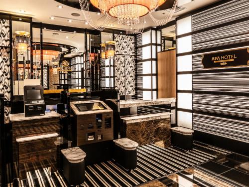 a lobby of a fashion store with a cash register at APA Hotel SHIN-OSAKA MINAMIKATA EKIMAE in Osaka
