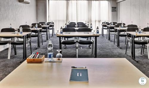 an empty room with tables and chairs and water bottles at L'Initial in Toulouse