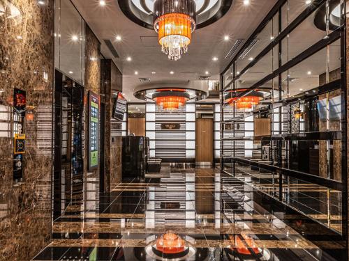a lobby of a building with a chandelier at APA Hotel SHIN-OSAKA MINAMIKATA EKIMAE in Osaka