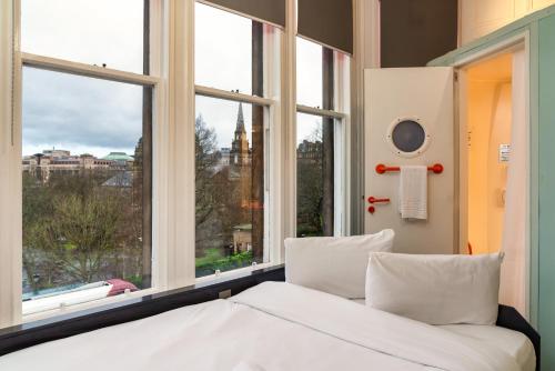 a bedroom with a bed and a large window at easyHotel Edinburgh in Edinburgh